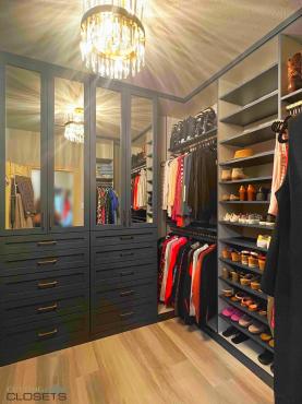 Matte black shaker-style closet doors with modern built-in storage system